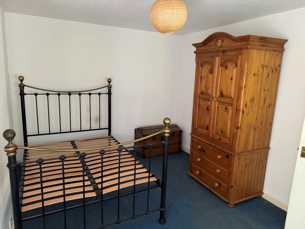 Lot: 118 - TOWN CENTRE FLAT FOR IMPROVEMENT WITH PARKING - The bedroom shown from the window